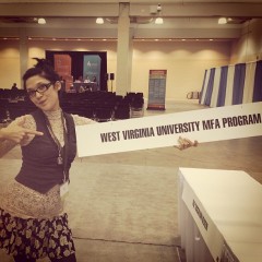MFA student Connie Pan holding WVU's sign at AWP